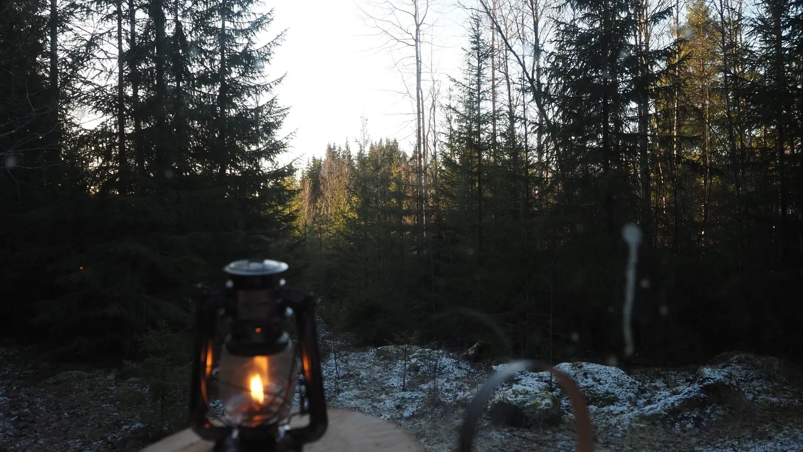 Lantern outside the cabin at dusk