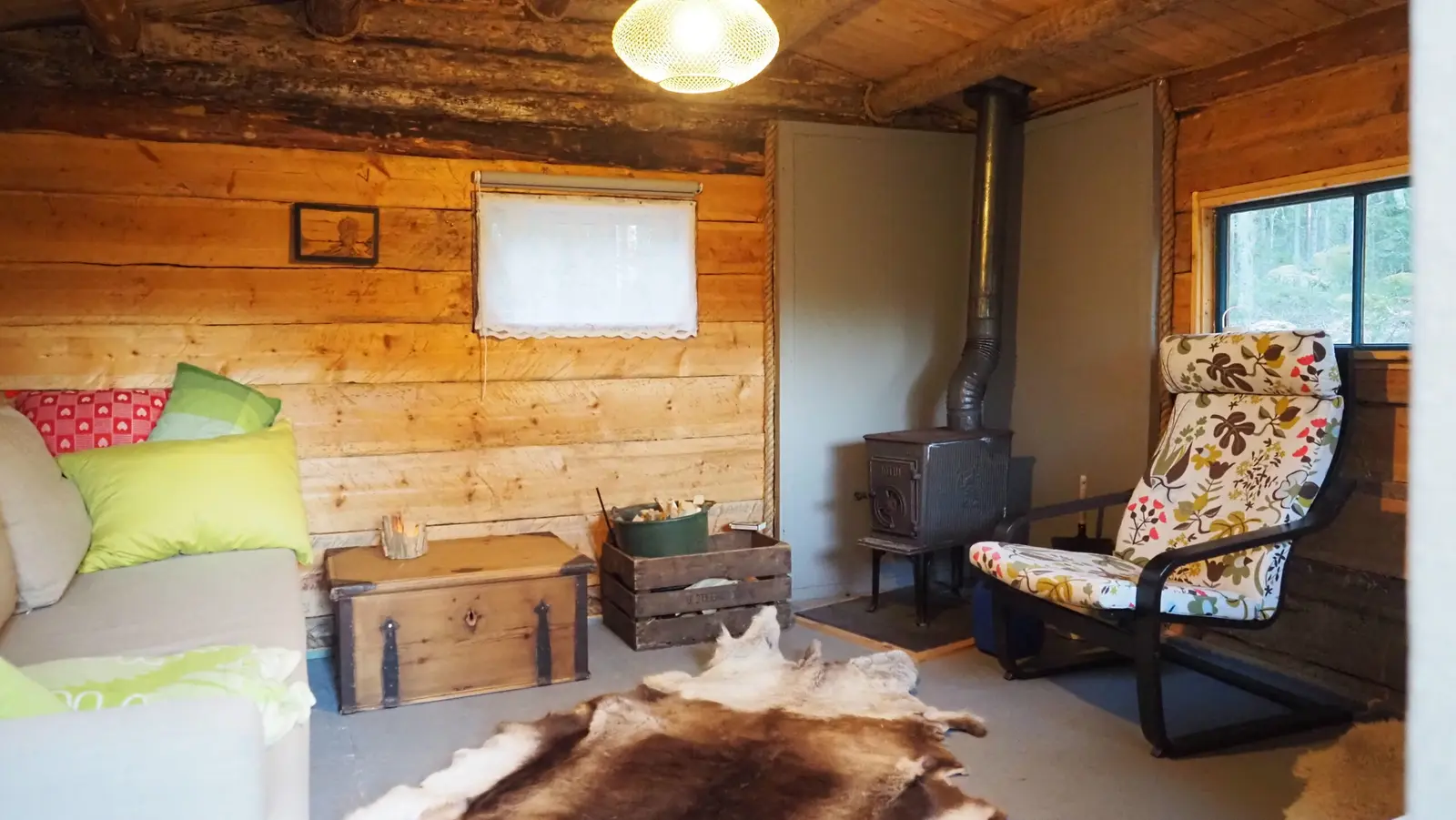 Sofa and wood stove inside the cabin