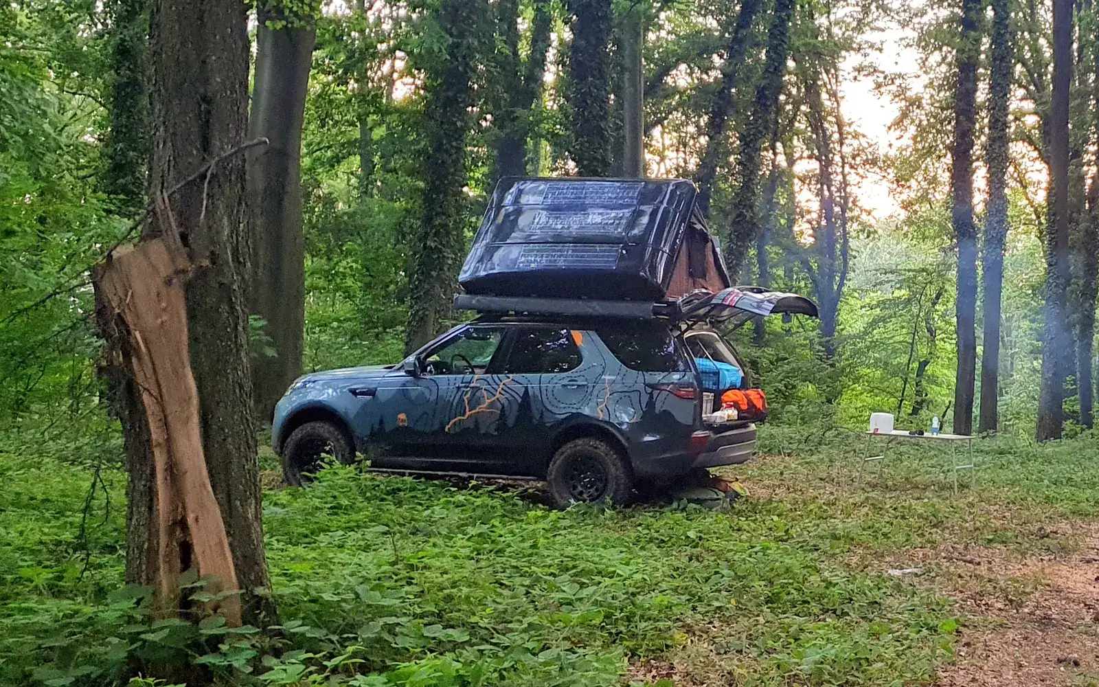 Land Rover Discovery at a forest camp