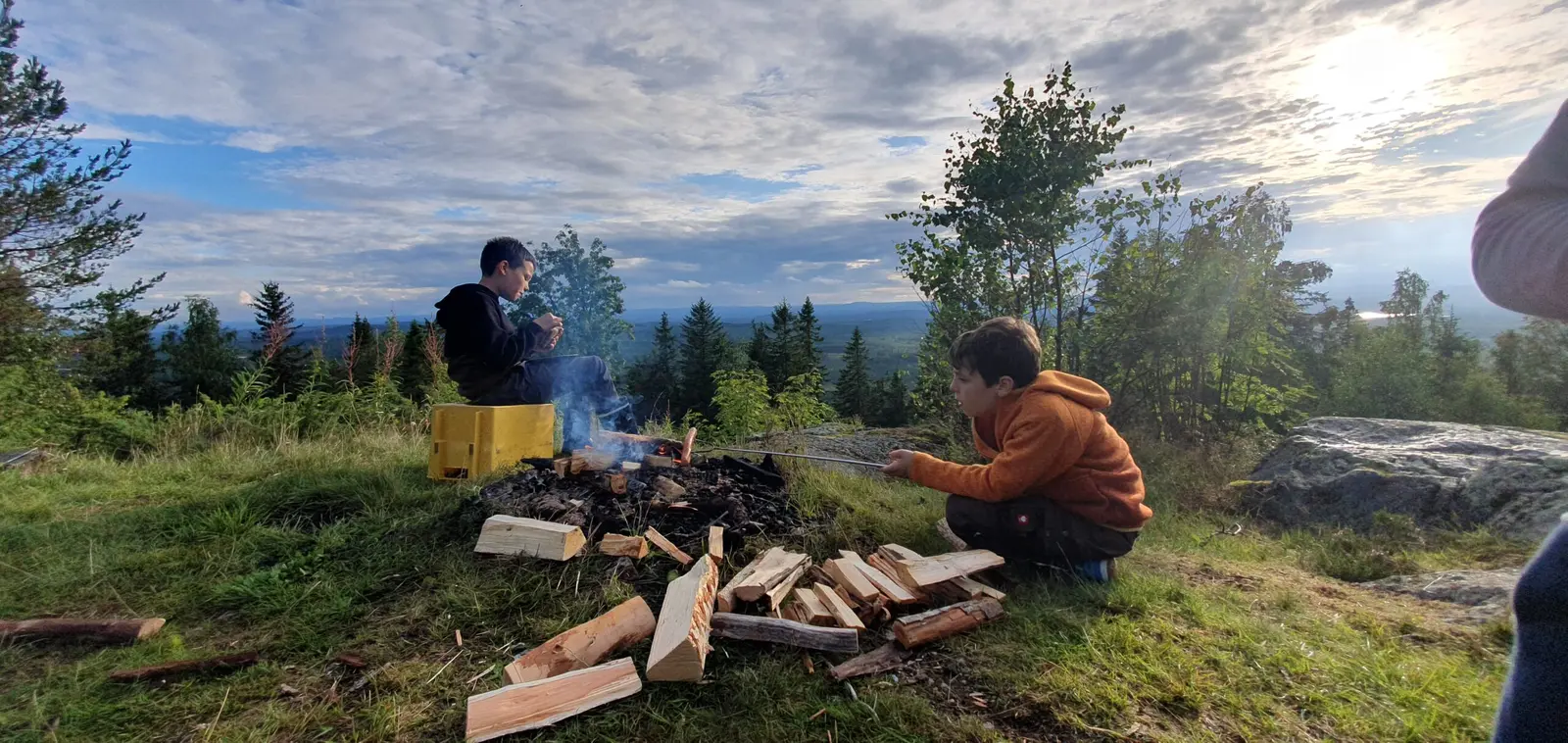 A family by the campfire next to their 4×4