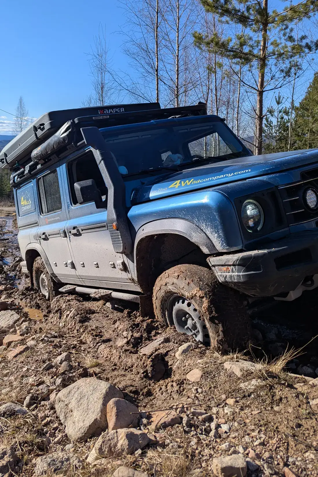 Ineos Grenadier on a muddy forest track