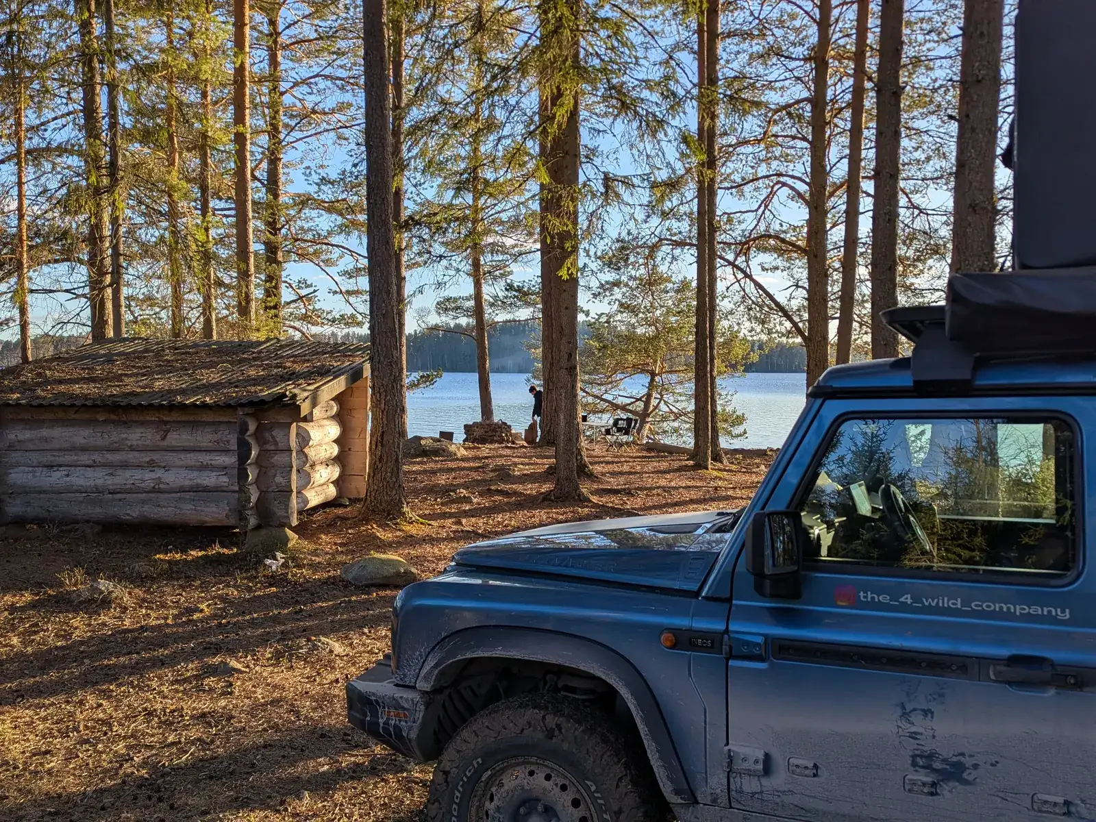 The Grenadier next to a log cabin by a lake
