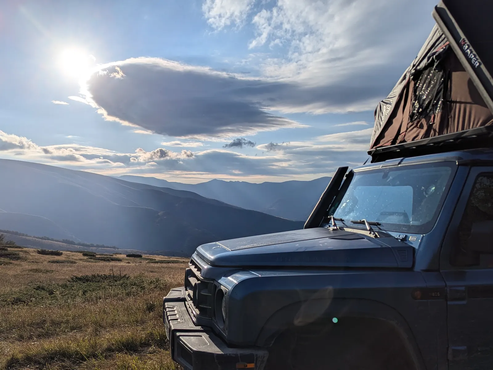 Ineos Grenadier in the mountains with low sun