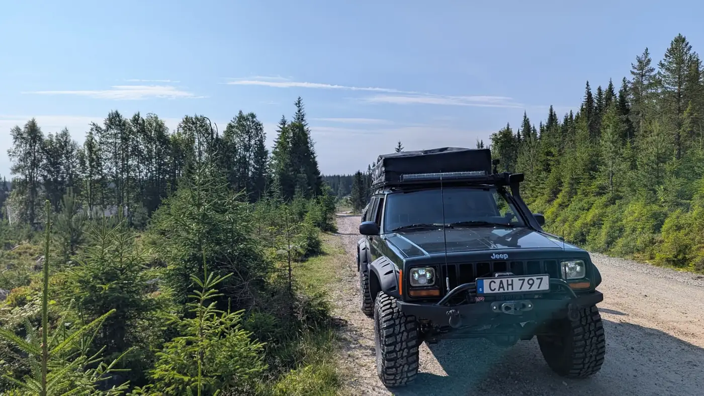 Jeep Cherokee XJ on a gravel forest road