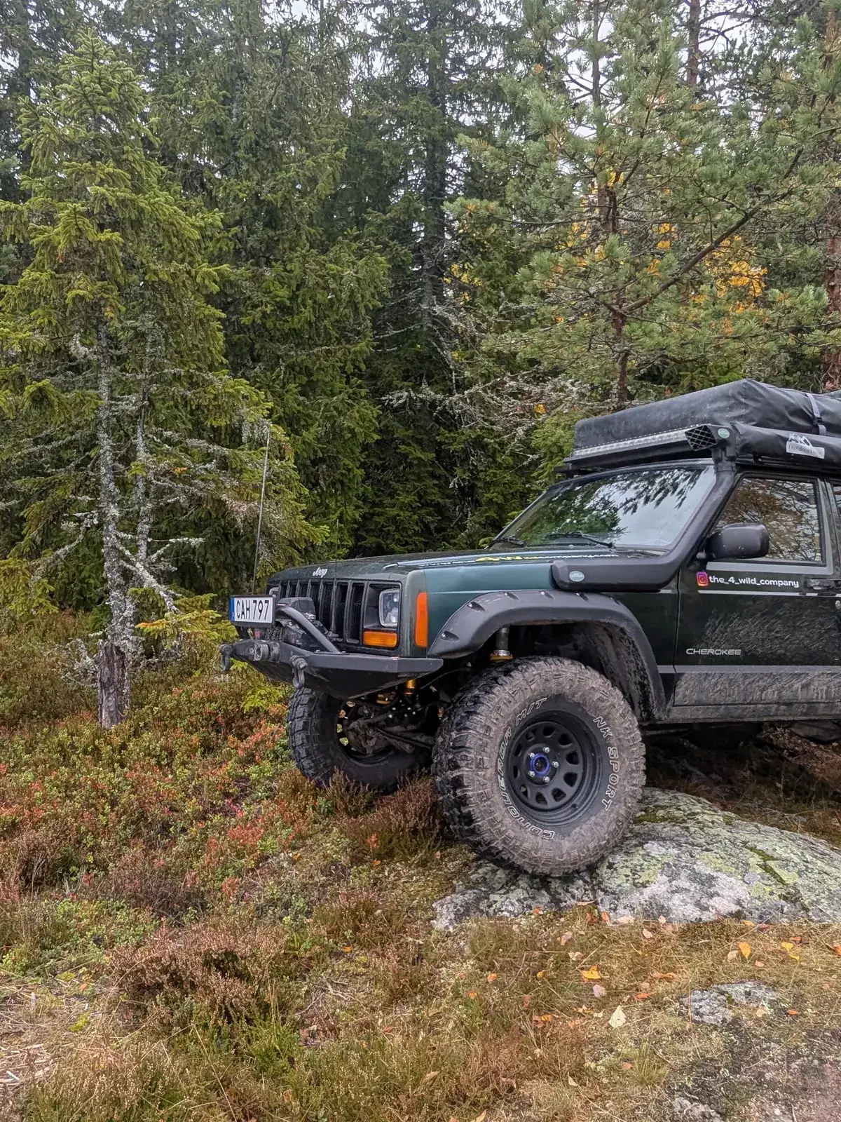 Jeep Cherokee XJ on a rock in the forest