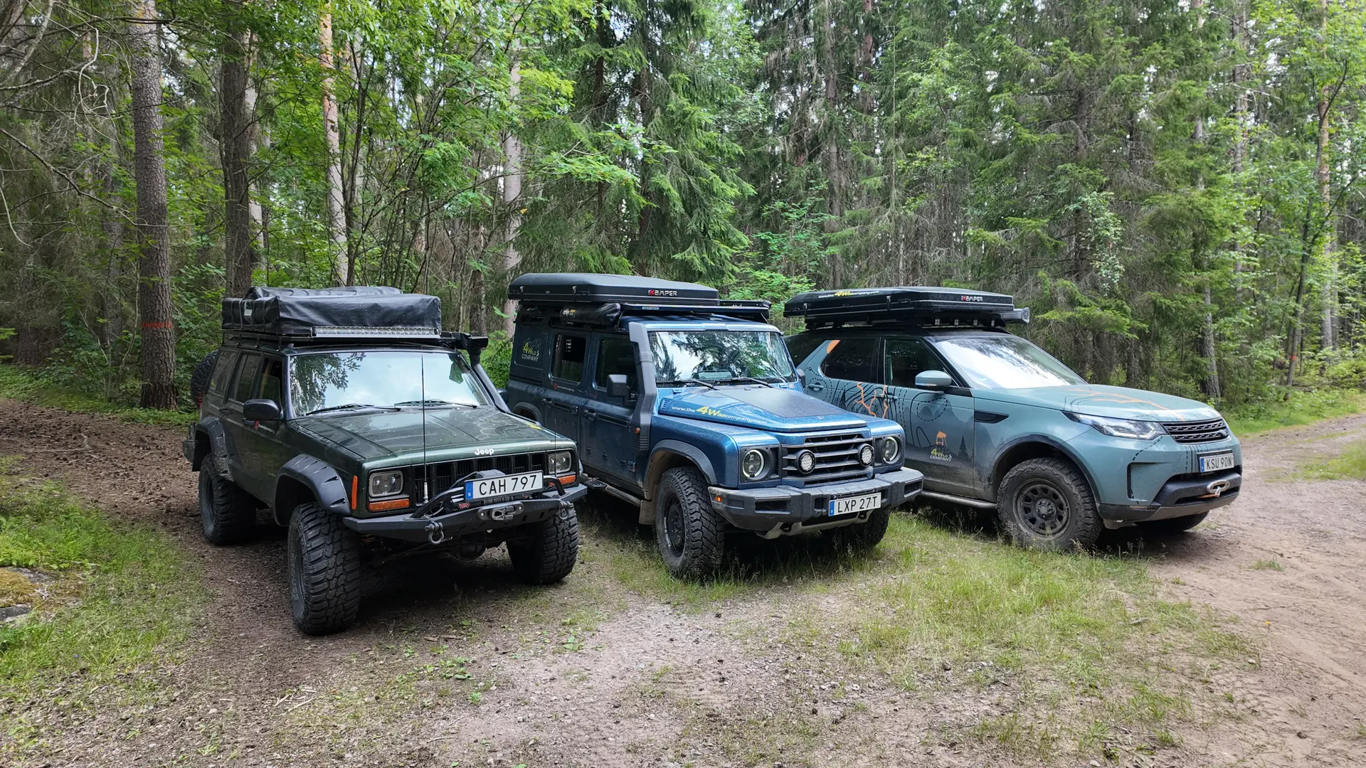 Our three 4×4 overlanders side by side in the forest