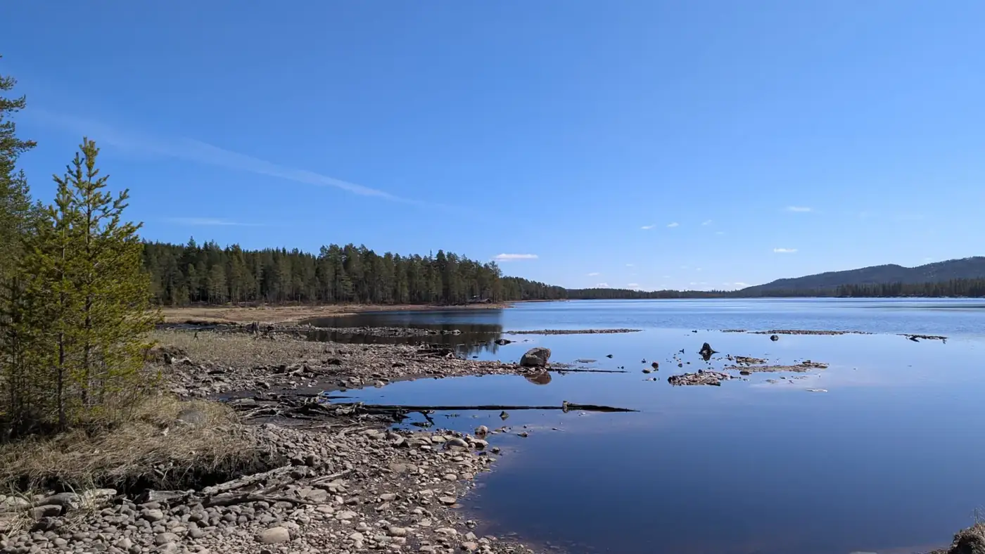 Rocky lake shore under a clear spring sky