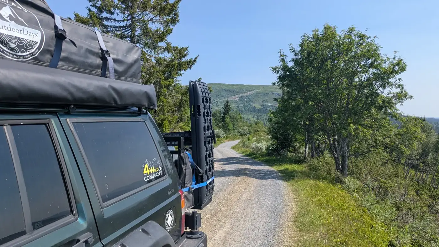 Jeep on a gravel road through the Norwegian forest