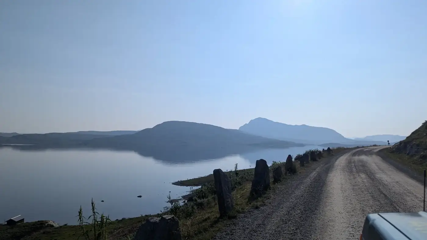 Gravel road along a quiet fjell lake