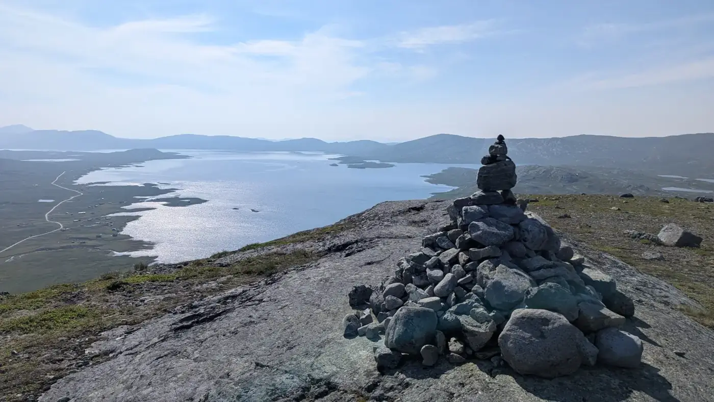 Stone cairn above a lake on the fjell
