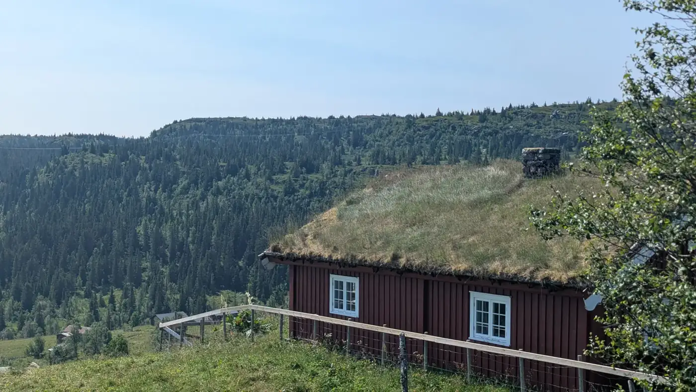Old farm with a turf roof on the way into the mountains