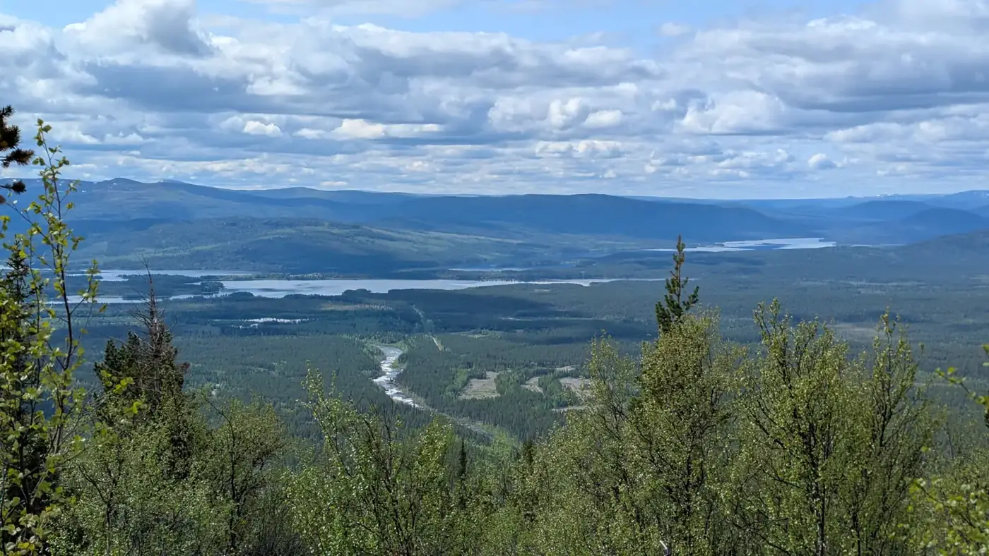 View over a wide valley towards the mountains around Sarek