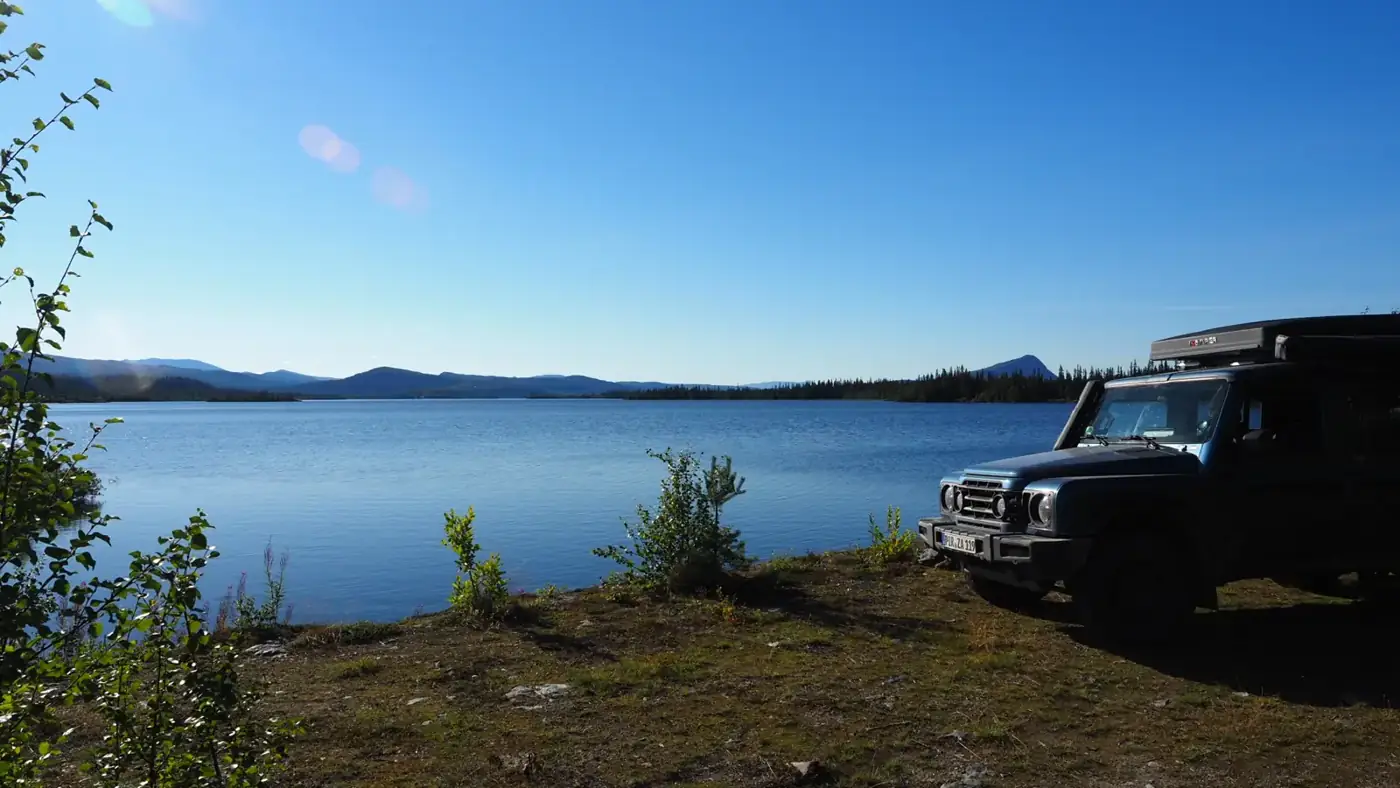 Our 4×4 parked by a lake in Lapland