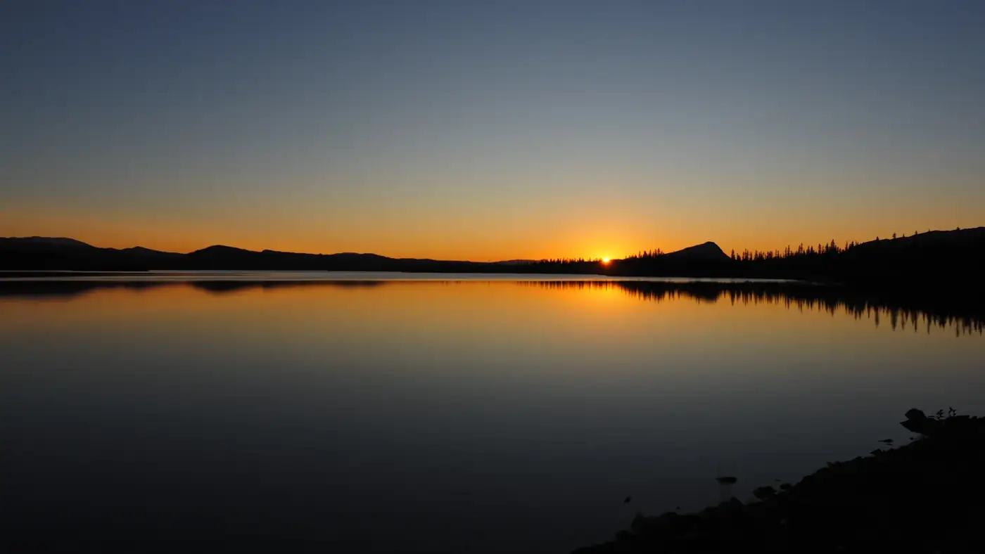 Sunset over a calm lake in Lapland
