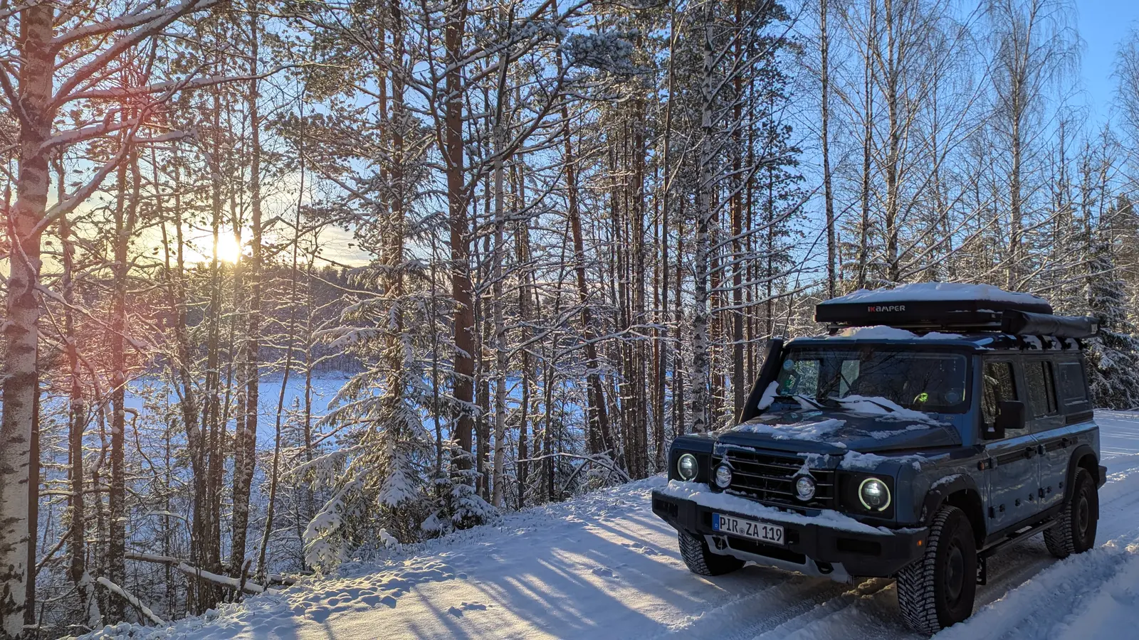 Ineos Grenadier on a snowy forest road in low sun