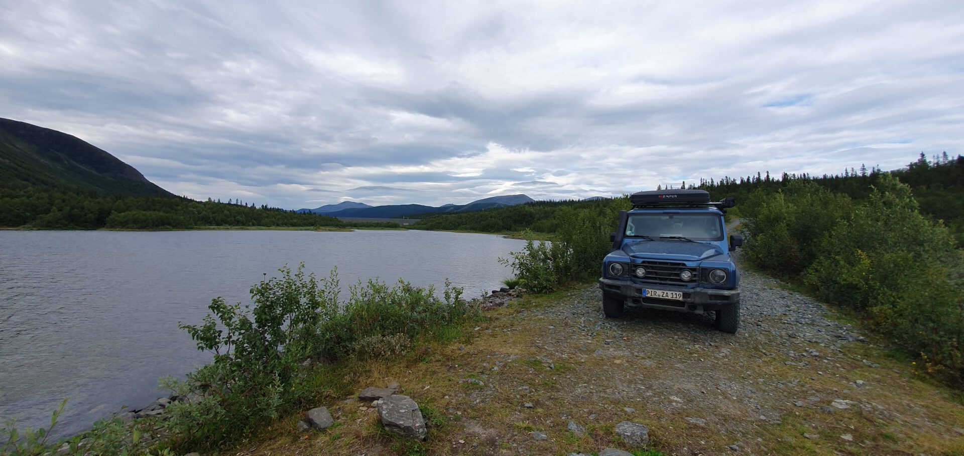 Grenadier jeep with ikamper rooftop tent near Swedish lake